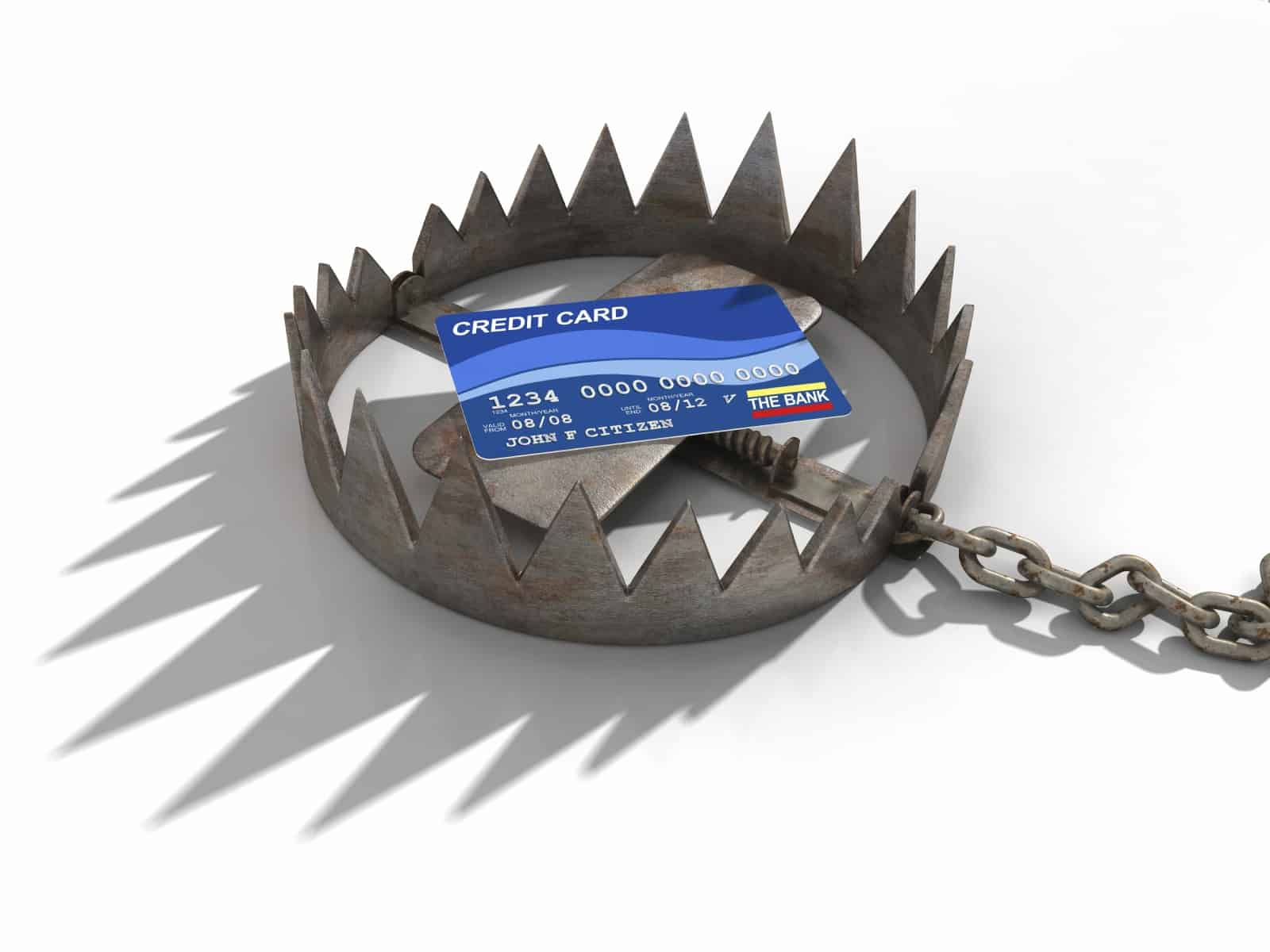 A credit card sitting on a rusty old bear trap. Credit risk concept. Very high resolution 3D render.