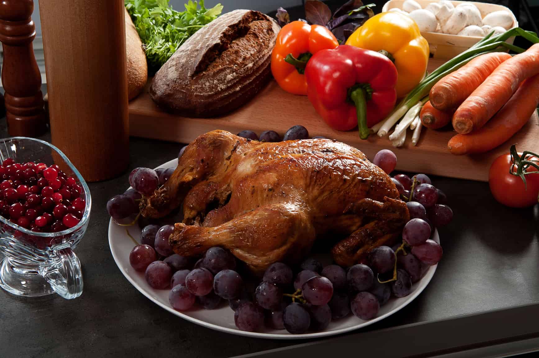 Roasted holiday turkey garnished with sourdough stuffing and fruit
