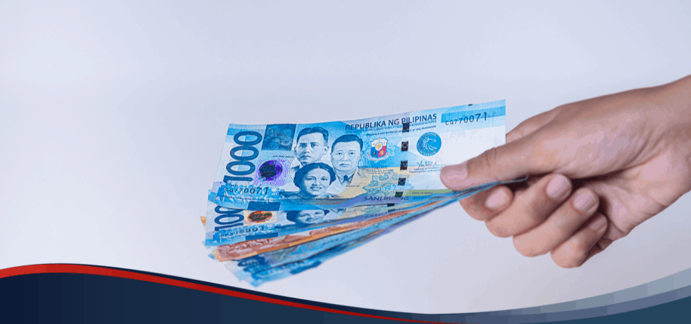 Hands holding set of 1000-peso bills