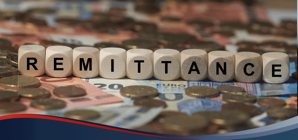 Boggle cubes that spell "Remittance" over Philippine bills and coins
